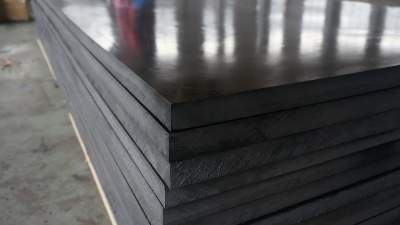 A close-up shot showing the smooth, waxy texture of a UHMWPE sheet.
