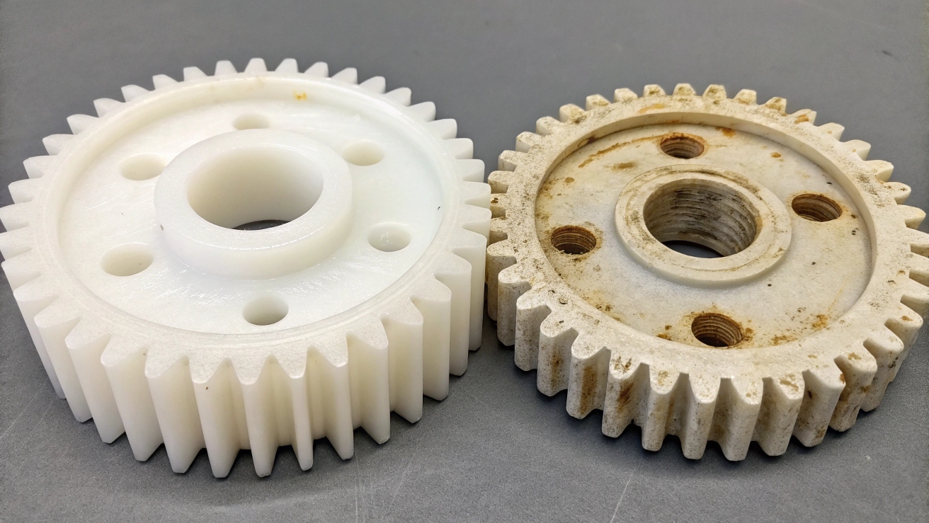 A comparison photo showing a pristine UHMWPE gear next to a worn-out gear made of a lesser plastic.